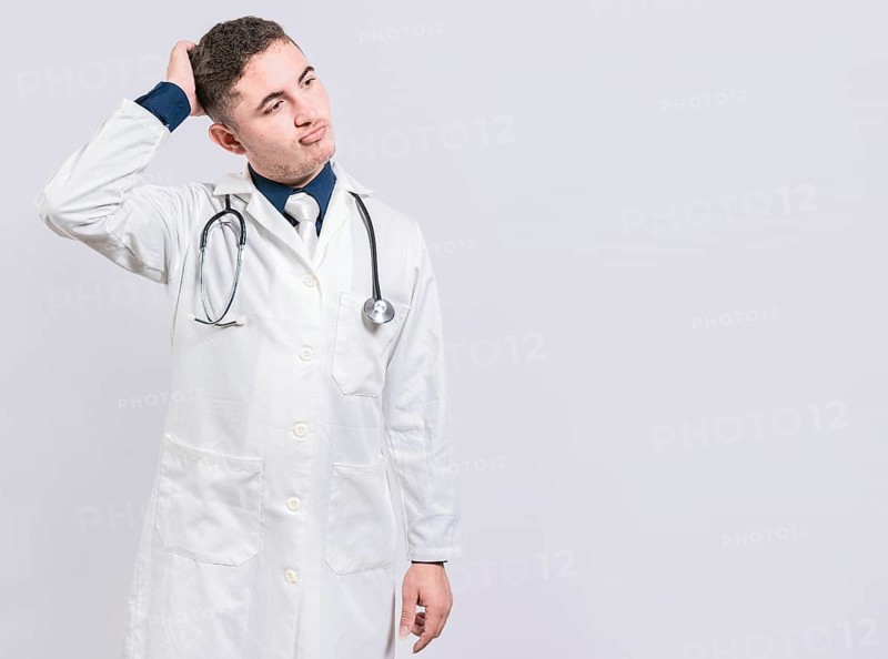 Confused and thoughtful doctor isolated. Uncertain doctor scratching head isolated. Thoughtful doctor scratching head