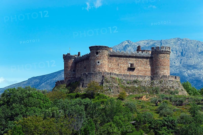 Medieval castle on a hill surrounded by nature with majestic mountains in the background, Castillo de Mombeltrán, Mombeltran, Ávila, Avila, Castilla y León, Leon, Spain, Europe
