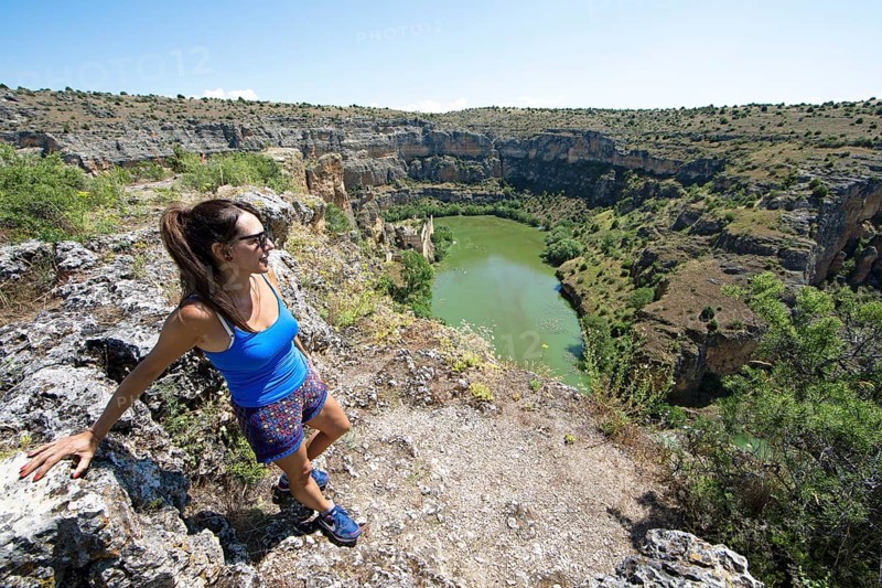 Castilian woman, 48 years old, looking at the gorge and the river Duratón, canoes on the water, on the left the Franciscan monastery La Hoz, Natural Park Hoces del Rio Duratón, province Segovia, Castilla y León, Spain, Europe
