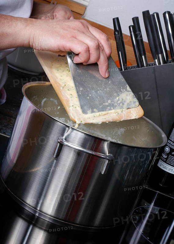 Swabian cuisine, preparation of herb spaetzle for roast beef, scraping spaetzle, spaetzle board, dough, cooking pot, savoury, salty, typical Swabian, home cooking, traditional cuisine, men's hands, food photography, studio, Germany, Europe
