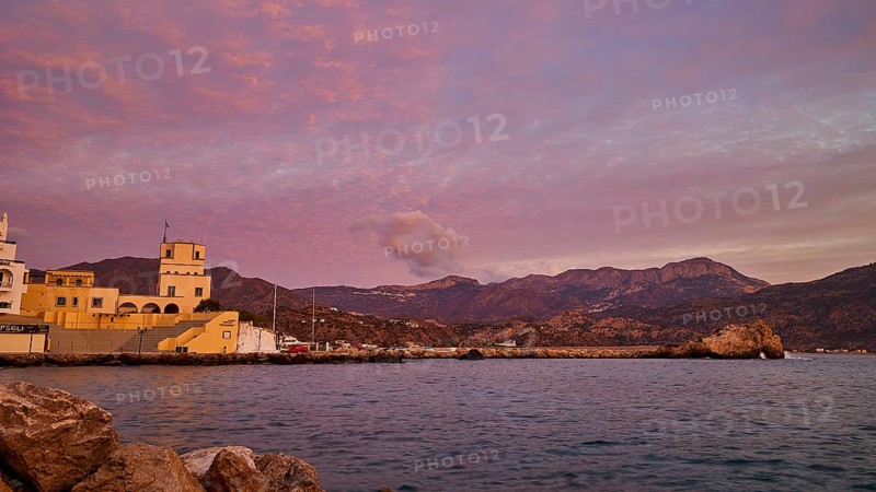 Romantic picture of the coast at dawn, with historic buildings on the shore and mountainous landscape in the background, Pigadia, town and harbour, Pigadia Bay, main town, Karpathos, Dodecanese, Greek Islands, Greece, Europe