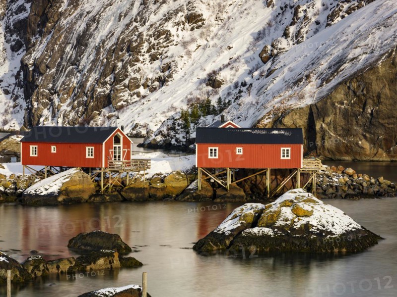 Traditional red rorbu houses on stilts in the authentic fishing village of Nusfjord, Flakstadøya, Lofoten, Norway, Europe