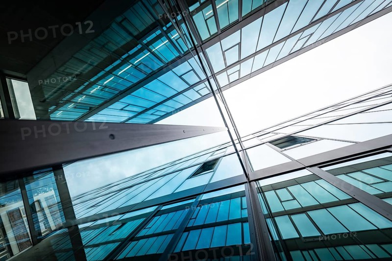 Mirrored glass facades of modern buildings reach up into the sky, reflecting blue and white, University of Stuttgart, Germany, Europe