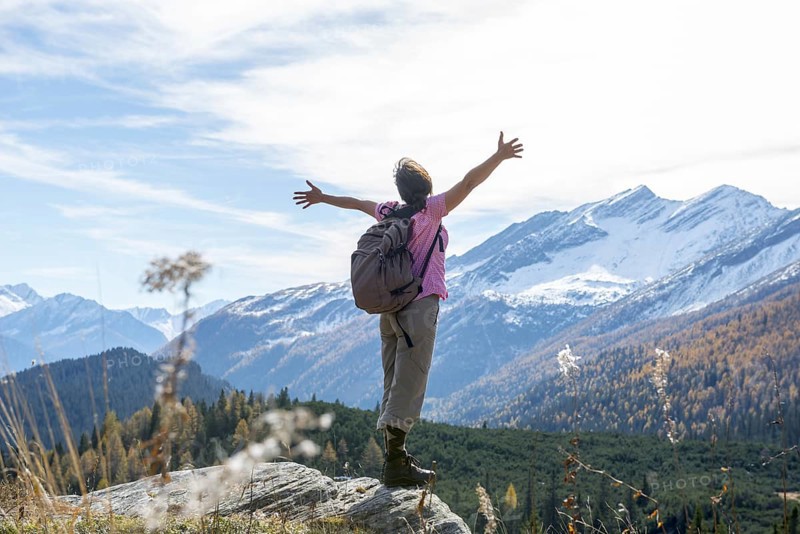 Woman Hiking and with Her Arms Outstretched and Enjoy Mountain Scape with Snow in San Bernardino, Grisons, Switzerland, Europe