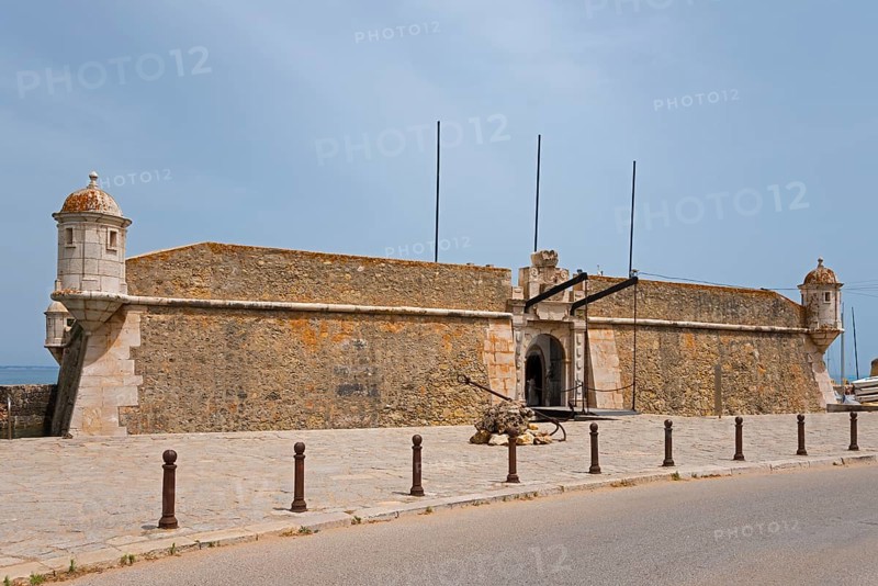 Old stone fortress by the road under a blue sky, Forte da Ponta da Bandeira, Fortress, Lagos, Algarve, Portugal, Europe
