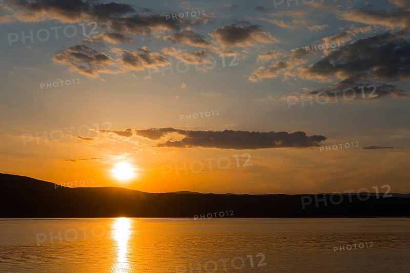 Orange-coloured sky at sunset over a calm sea, Glavotok, island of Krk, Primorje-Gorski kotar, Croatia, Europe