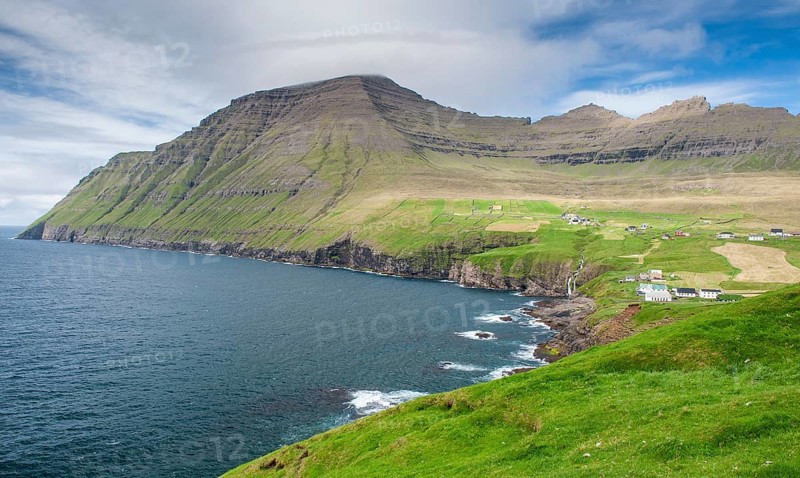 Green coastal landscape with mountains and houses under a blue sky, Vidareidi, Vidoy Island, Viðareiði, Viðoy Island, Faroe Islands, Denmark, Europe