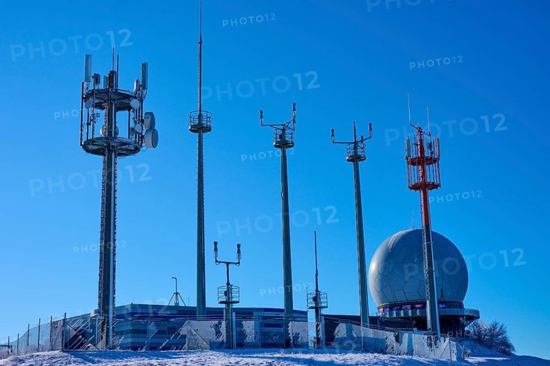 Several transmission masts and a radar station Radom in clear weather with snow and blue sky, winter, Wasserkuppe, Gersfeld, Rhön, Hesse, Germany, Europe