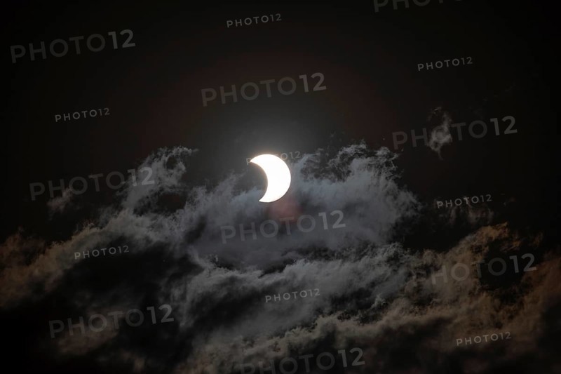 Partial solar eclipse with light cloud cover on 2 October 2024 in Buenos Aires, Argentina, South America