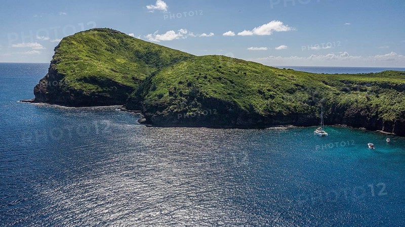 Bird's eye view Aerial view of cape high cliffs steeply rising rocks of Isle de Coin de Mire, Gunner's Coin Island, Mauritius, Africa