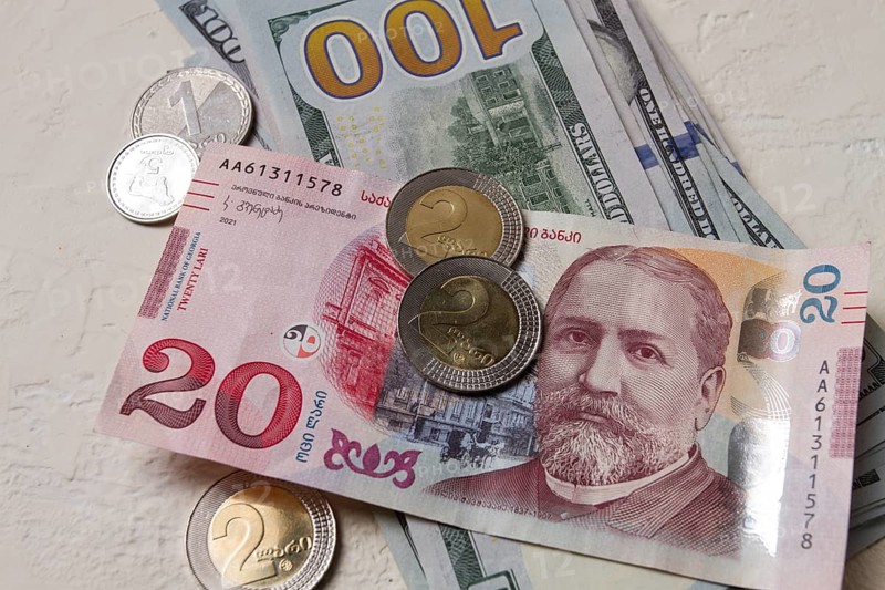 Lari, 20 GEL, Georgian monetary currency, with dollars, banknotes, top view, no people, on the table