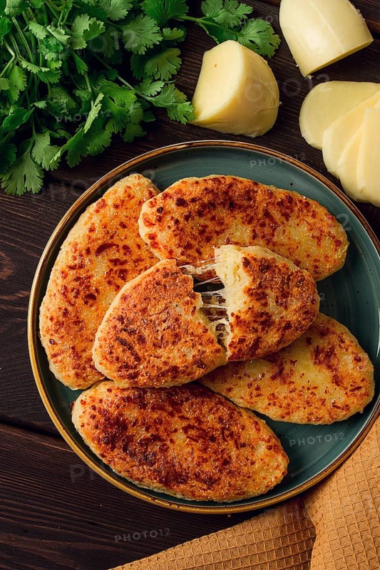 Chvishtari, corn flour tortillas with cheese, pastries, Georgian cuisine, Mchadi, homemade, top view, on a wooden table, no people