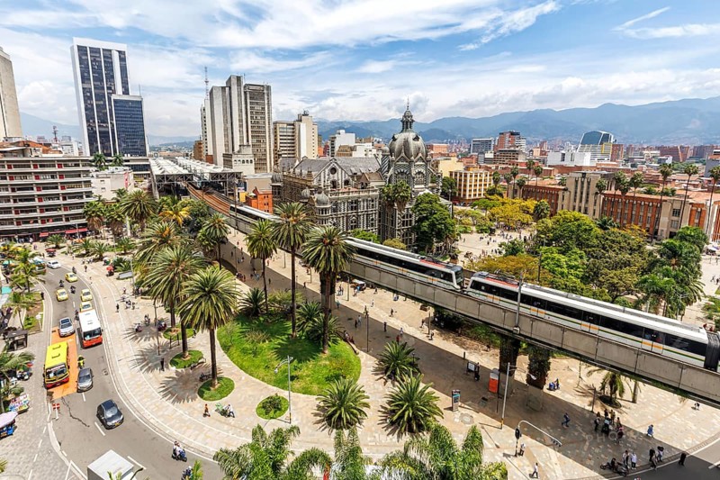 Medellin skyline with a train of the Metro de Medellín at Plaza Botero in Medellin, Colombia, South America