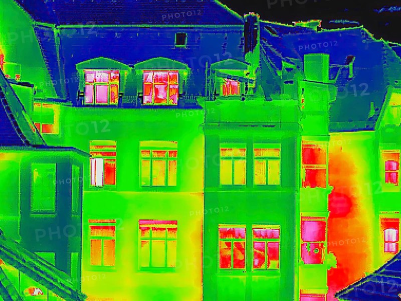 Apartment block, facade of a residential building with windows. Thermal image or thermography, symbol photo, interpolated. Germany