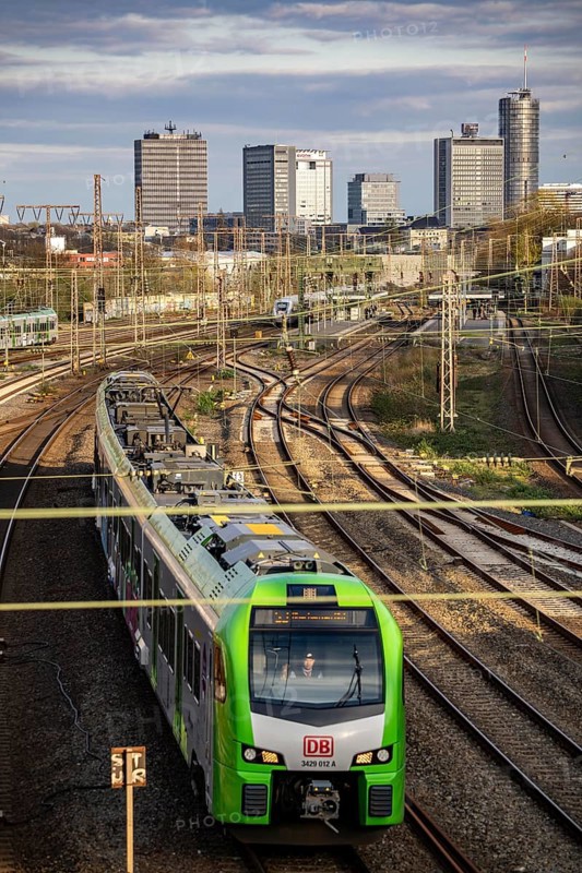 Train on the tracks west of Essen main station, skyline of the city centre, S-Bahn train, North Rhine-Westphalia, Germany, Europe