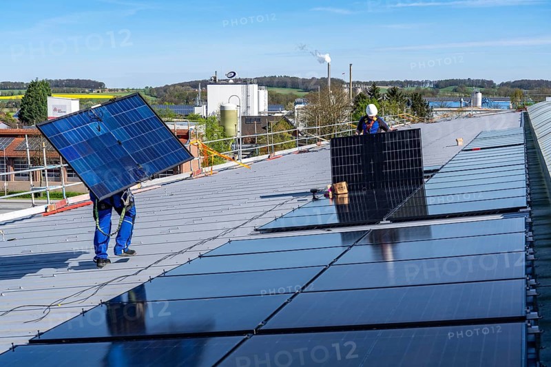 Installation of solar modules on the roof of a commercial enterprise, over 400 photovoltaic modules are installed on the roof, North Rhine-Westphalia, Germany, Europe