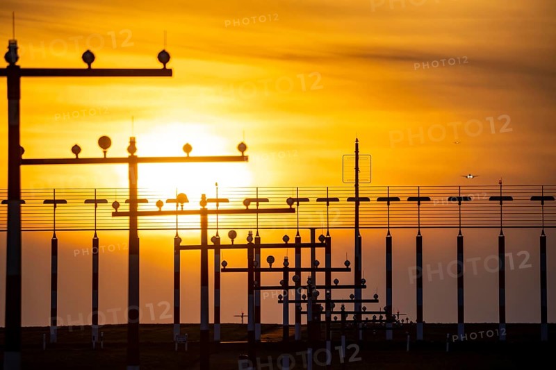 Runway lighting, approach aids, at Düsseldorf International Airport, sunset, aircraft approaching the main runway south, 05R/23L, North Rhine-Westphalia, Germany, Europe