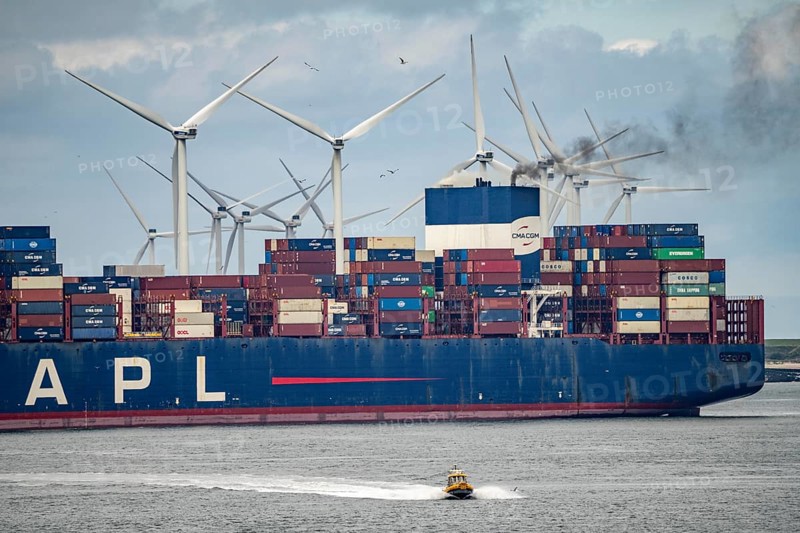 Entrance to the seaport of Rotterdam, APL Raffles container freighter, entering Maasvlakte 2, wind farm, Rotterdam Netherlands