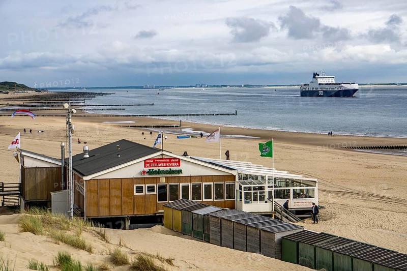 Beach restaurant, Strandpaviljoen De Zeeuwse Rivièra, on the North Sea beach near Zoutelande, Zeeland, DFDS cargo ferry, breakwater at low tide, dunes, Netherlands