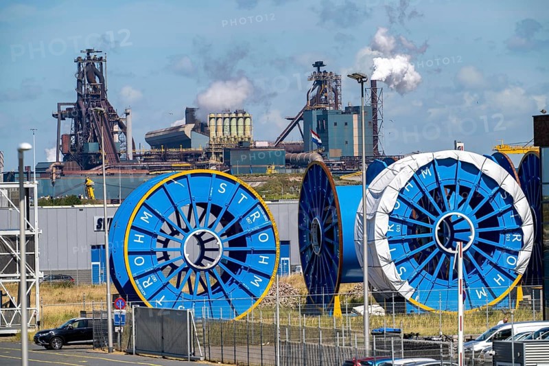 Cable drums for TCP pipes that transport hydrogen from offshore wind farms to land, special production of the TCP pipes by the Strohm company, at the mouth of the river Ij, Ijmuiden aan Zee, in the background the Tata Steel steelworks