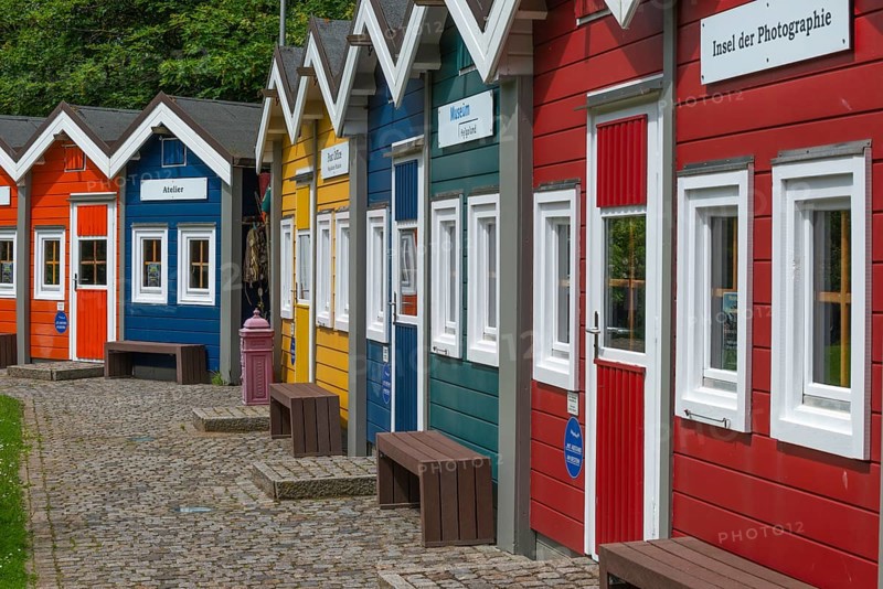 Colourful lobster shacks in the outdoor area of the museum with different themed areas, benches, paved path, offshore island of Heligoland, North Sea, Pinneberg district, Schleswig-Holstein, Germany, Europe