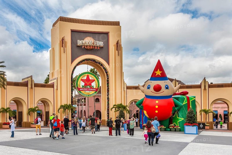 Arch at entrance to Universal Studios theme park in Orlando, Florida, USA decorated for the Christmas holiday season