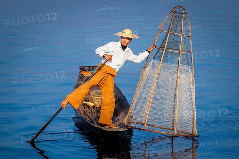 Myanmar travel attraction landmark, Traditional Burmese fisherman with fishing net at Inle lake in Myanmar famous for their distinctive one legged rowing style