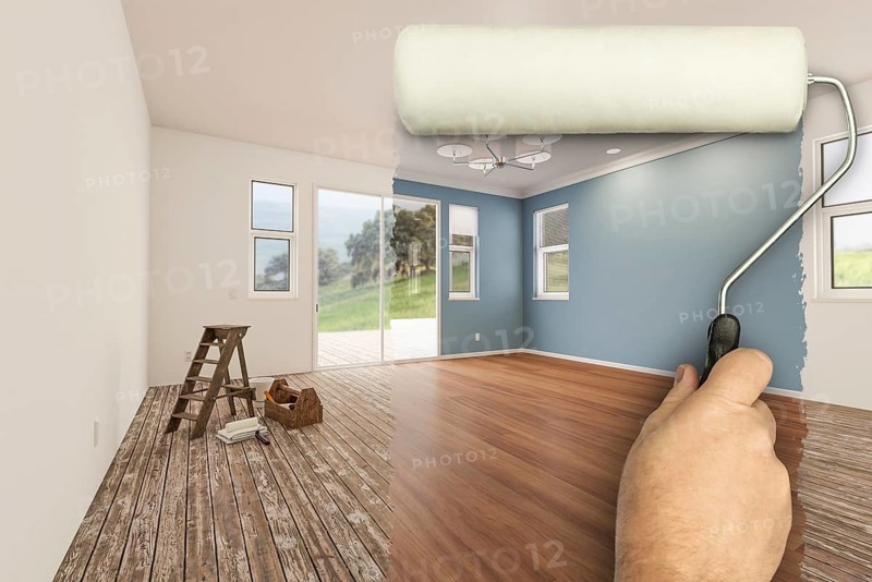 Before and after of man using A paint roller to reveal newly remodeled room with fresh green paint, coffered ceiling and new floors