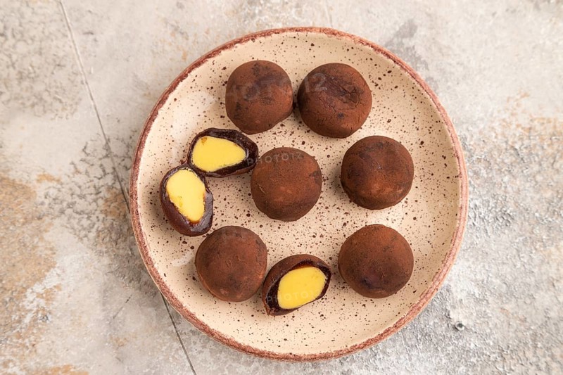 Japanese rice sweet buns chocolate mochi filled with cream on brown concrete background. top view, flat lay, close up