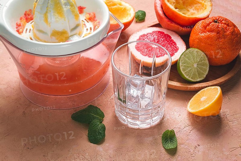 Citrus juicer, sliced fruit, glass with ice, close-up, no people, breakfast