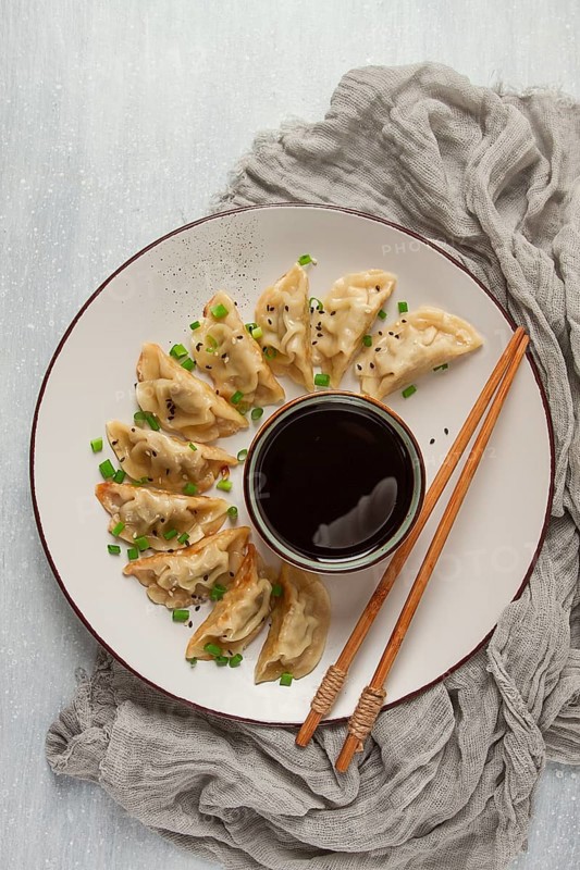 Japanese Gyoza dumplings, fried, with sauce, top view, without people, tinted, selective focus