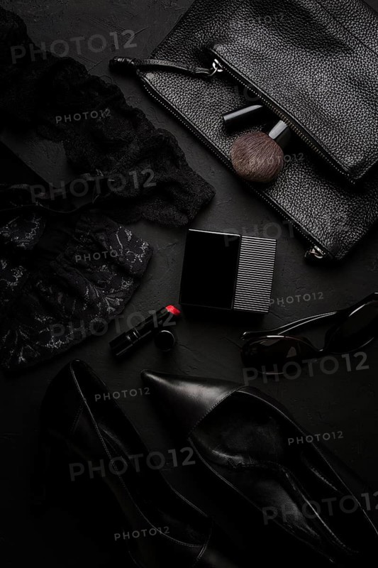 Women's accessories, black heeled shoes, cosmetics, underwear, top view, on a black background, perfume, lipstick, sunglasses, monochrome