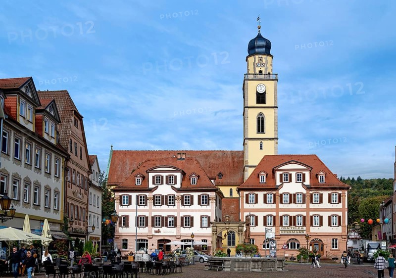 The twin houses built in the early classicist style with church tower on the market square in the old town centre of Bad Mergentheim. Baden-Wuerttemberg, Germany, Europe