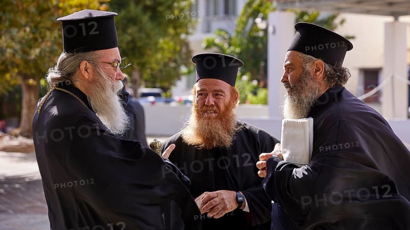 Three orthodox priests, including Archbishop Amphilochios, in conversation outdoors, Visit of Federal President Frank-Walter Steinmeier to Kandanos on 31 October 2024, Federal President, Frank-Walter Steinmeier, memorial, war crimes, Nazis, Wehrmacht crimes, World War II, Kandanos, southwest Crete, Crete, Greek islands, Greece, Europe