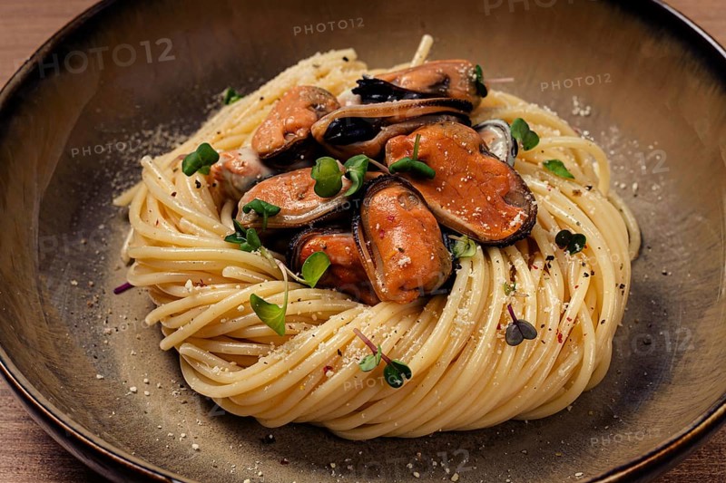 Spaghetti with mussels, without shell, pasta with peeled mussels, in carbonara sauce, micro-greens, homemade, no people