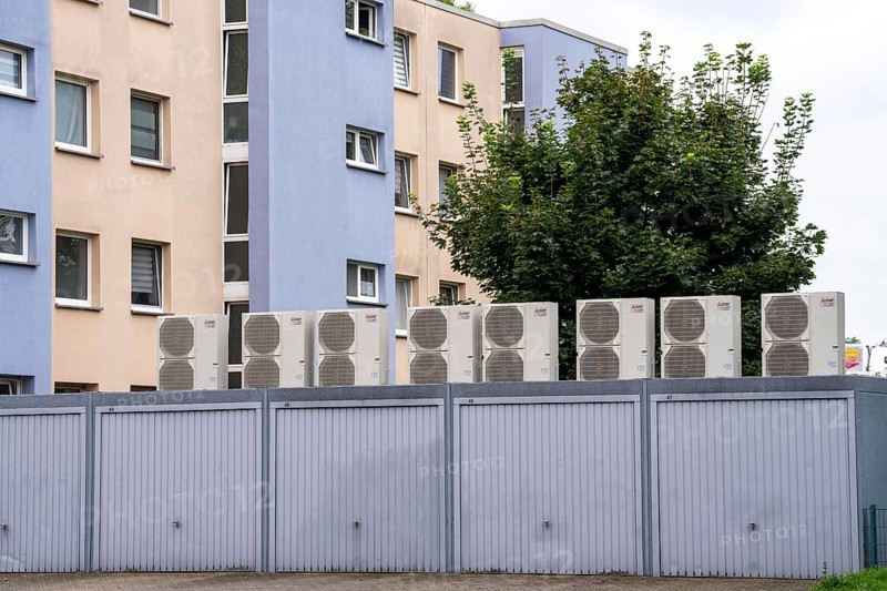Heat pumps in a residential area, multi-family houses are supplied with heating, cooling and domestic hot water via these devices, installed on garage roofs, modernisation of the flats, Duisburg, North Rhine-Westphalia, Germany, Europe