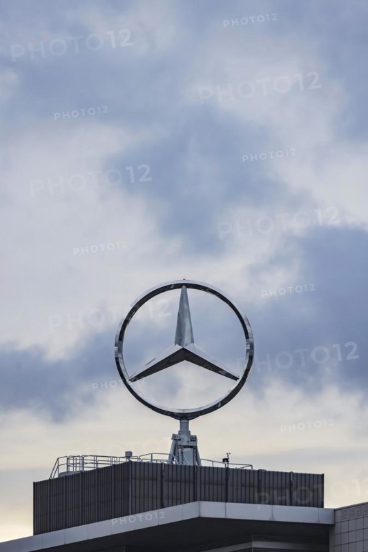 Mercedes star in front of dark clouds, office building at the headquarters of Mercedes-Benz Group AG in Untertürkheim, Stuttgart, Baden-Württemberg, Germany, Europe