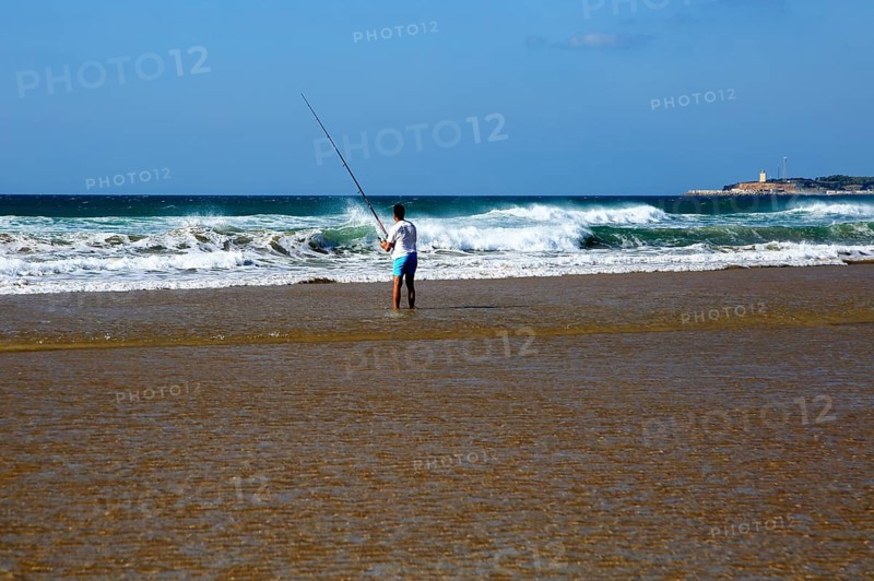 Man fishing from the beach at Conil de la Frontera, Cadiz province, Spain, Europe