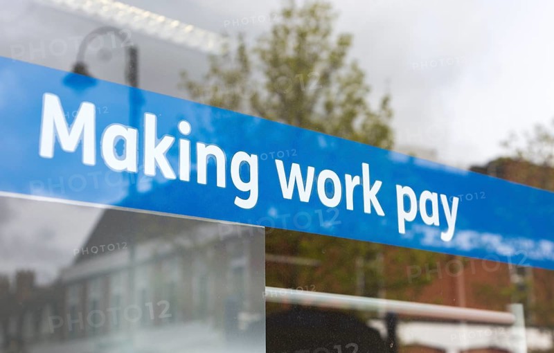 Making Work Pay banner in window of Jobcentre Plus office, Department for Work and Pensions, Devizes, Wiltshire, England, UK
