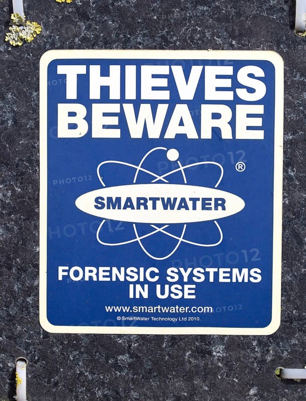 Close up of sign Thieves Beware Smartwater forensic systems in use, UK