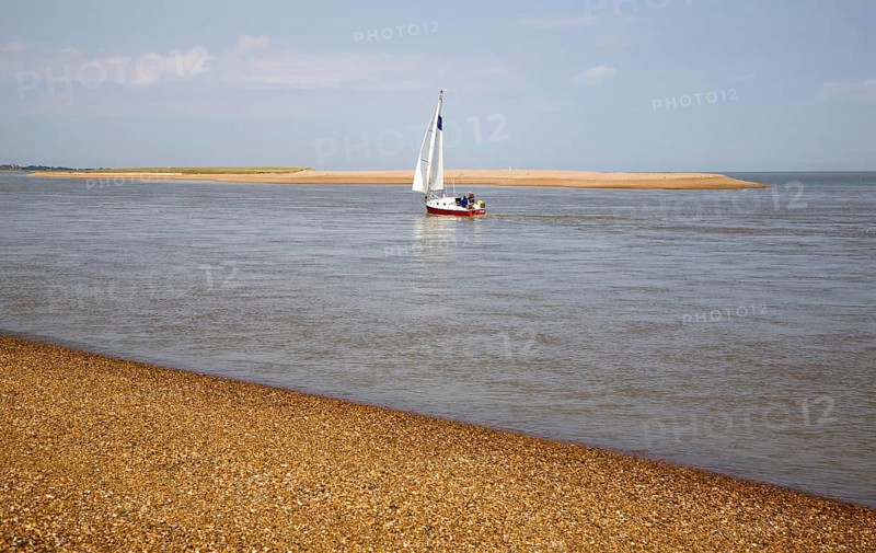 Sailing boat at the mouth of the River Ore at the tip of Orford Ness shingle spit, North Weir Point, Shingle Street, Hollesley, Suffolk, England, United Kingdom, Europe