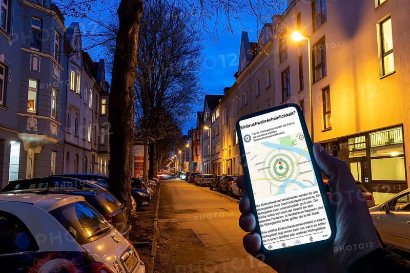 Symbolic image residential burglary, burglary radar app, MehrWetter app, shows the burglaries in the city, the last few days, residential street, many apartment buildings in a residential neighbourhood, evening, lantern lighting, Essen, North Rhine-Westphalia, Germany, Europe