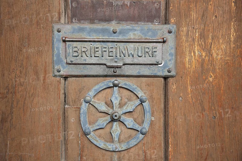Letter box with city coat of arms, wooden door with fittings, inscription, metal, sheet metal, detail, round, brown, black, letter slot, rosette, detail, fish market, Erfurt, Thuringia, Germany, Europe