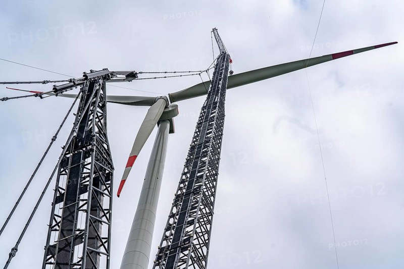 Erection of a wind turbine, wind energy plant, assembly of the third blade, with a crawler lattice crane, wind farm near Hagen, North Rhine-Westphalia, Germany, Europe