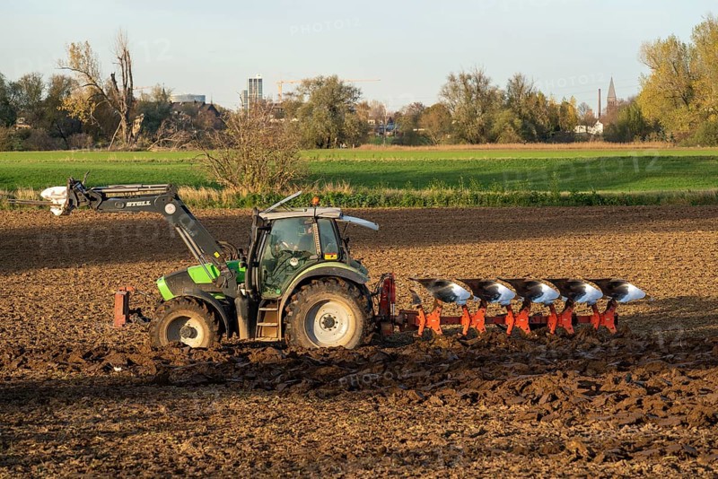 Farmer ploughing a field, tractor with plough, near Neuss, North Rhine-Westphalia, Germany, Europe