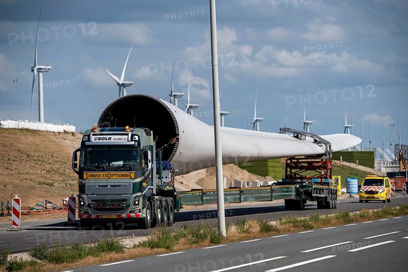 Wind farm under construction, on Maasvlakte 2, new part of the port of Rotterdam, 22 onshore wind turbines are being erected there on the coastline, the artificial island, type Eneco, transport of a rotor, Netherlands
