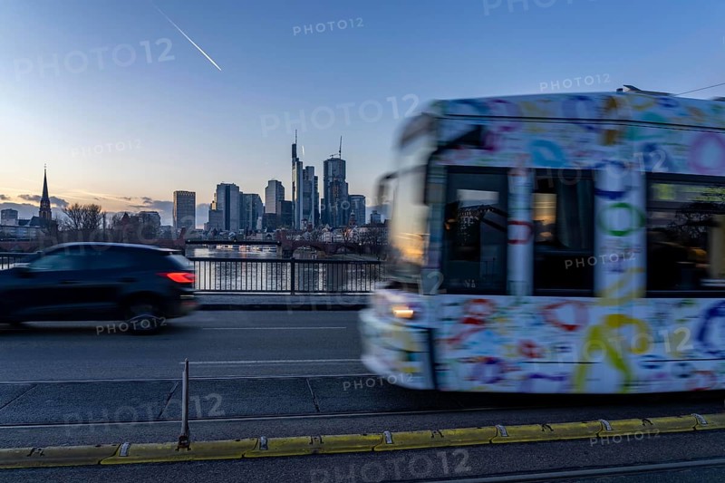 Skyline of the city centre of Frankfurt am Main, tram on the Ignatz-Bubis-Bridge, dusk, river Main, winter, Hesse, Germany, Europe