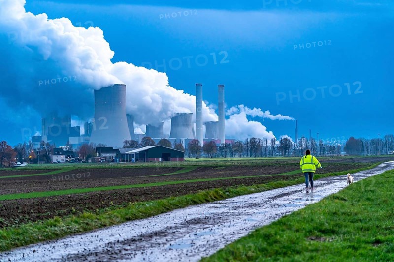 Field path, woman walking her dog, lignite-fired power plant, RWE Power AG Niederaußem power plant, near Bergheim, North Rhine-Westphalia, North Rhine-Westphalia, Germany, Europe