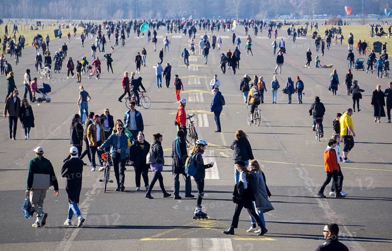 Thousands of people enjoying the first warming rays of sunshine on Tempelhofer Feld, not easy to comply with the coronavirus social distancing rules, Berlin, 21 February 2021