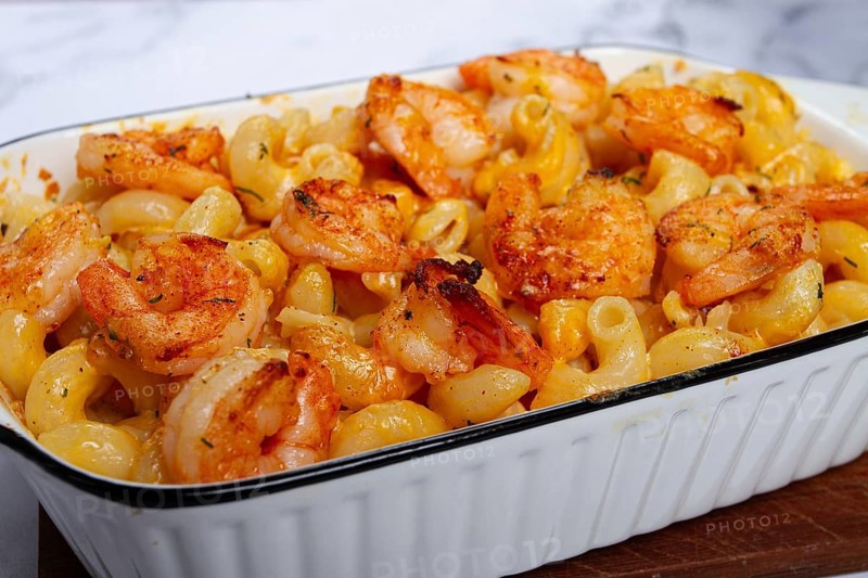 Pasta with shrimp and cheese, with a golden crust, cooked in a baking dish, homemade, no people